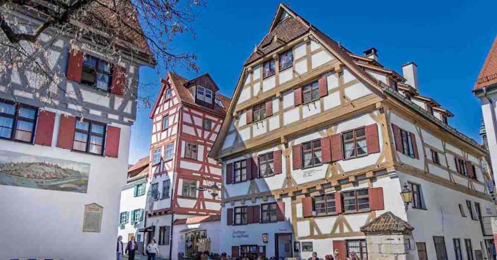 The historic Zunfthaus der Schiffsleute building with traditional half-timbered architecture and red shutters in the Fishermen's Quarter of Ulm, Germany.